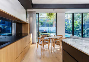 Modern kitchen with marble countertops and glass windows showcasing contemporary design