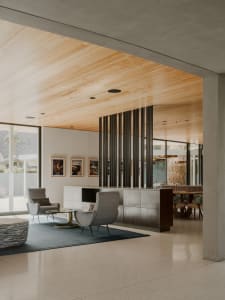 A modern living room featuring concrete and wooden elements.