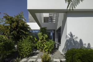 Modern residential building with concrete walls and glass windows.