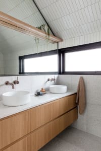 Modern bathroom featuring concrete floating vanity and double sinks.