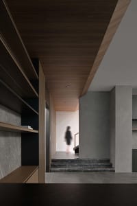 A minimalist modern entryway with concrete and wooden elements