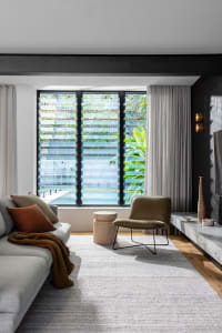 A modern living space featuring concrete and glass materials.