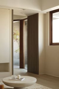 Modern minimalist interior with wood and stone materials.