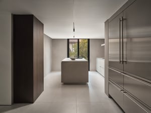 Contemporary kitchen with concrete countertop and minimalist island.