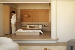 A minimalist bedroom with a wood platform bed, white bedding, and a wooden slat partition.