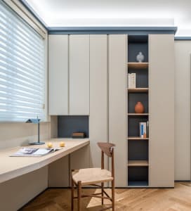 A minimalist home office featuring neutral-toned furniture and decor.