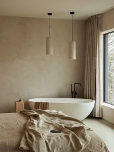 A minimalist bedroom featuring a cotton-blend blanket and curtains.