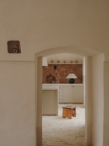 A minimalist-style interior space featuring tile and cement materials.