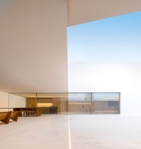 Modern interior design featuring glass and concrete materials.