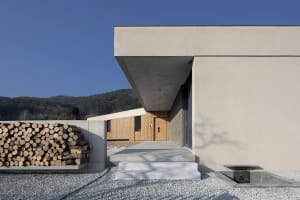 A modern residential building with concrete walls and a minimalist design.