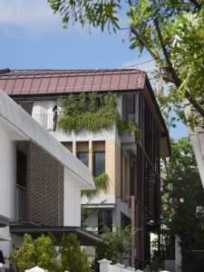 Modern building exterior featuring a green roof with plants.