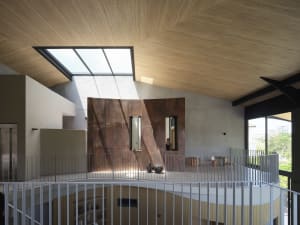Modern interior design featuring metal-clad walls and a central atrium