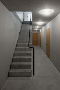 Concrete stairwell with minimalist design and dark color.