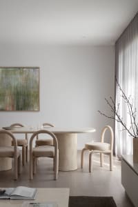 Modern dining room with marble table and minimalist design.