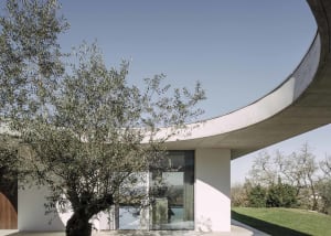 A modern, minimalist residential building constructed with concrete materials.