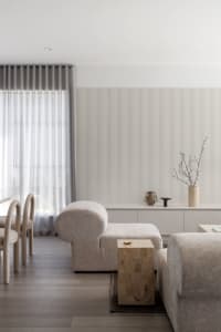 A minimalist living room featuring neutral fabrics and a modern, clean design.