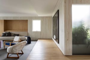 A modern living room featuring wood and concrete materials.