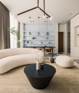 A modern living room with a circular sofa, black and white decor, and a minimalist design aesthetic.