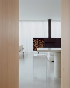 Modern minimalist residential interior with concrete elements and a minimalist design aesthetic.