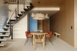 Contemporary dining room featuring wooden furniture and a woven pendant light.