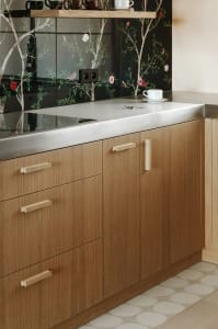 Modern, minimalist kitchen with wooden cabinets and stainless steel countertops.