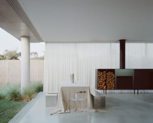A minimalist interior featuring a concrete floor and walls.