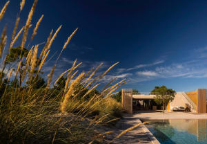 Modern residential building with glass facade and poolside area