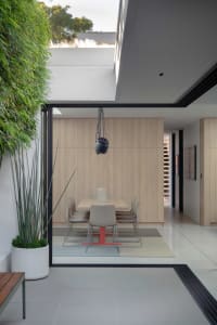 Modern dining room featuring wooden walls.