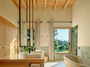 Modern bathroom featuring wooden surfaces and stone accents.