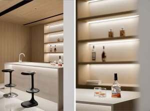 Modern bar with a concrete countertop and sleek stools.