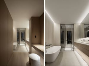 Modern, minimalist bathroom featuring a white bathtub and sleek, white furniture against light-colored walls and floors.