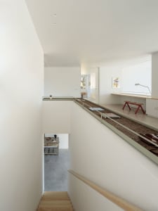 A modern workspace with concrete flooring, minimalist decor, and a sleek, industrial aesthetic.