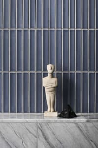 A minimalist interior design featuring marble and concrete materials.