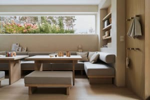 A modern living room with metal, wood, and fabric materials.
