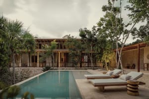 Poolside lounge area featuring modern design elements such as wood, stone, and concrete.