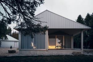 Modern minimalist residential house with metal siding and large glass windows