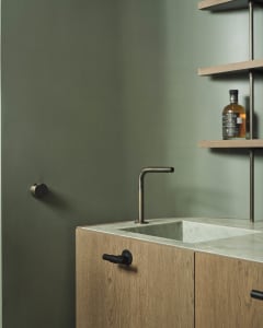 Modern interior design featuring a wooden bar counter adorned with marble surface and brass elements.