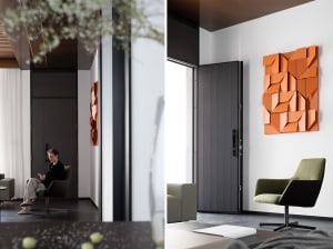 A modern entryway featuring a textured, orange paper panel wall decoration and a green office chair.