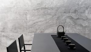Modern, minimalist tea ceremony setting with concrete walls and a black table.