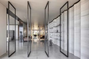 A modern minimalist living space with concrete walls and open layout.