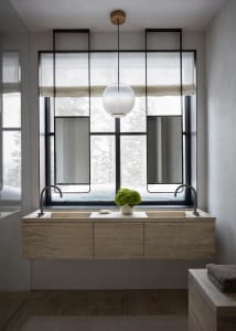 Modern minimalist bathroom with marble sink and large window.