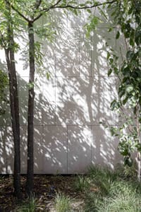 Modern minimalist architecture featuring concrete exterior walls with shadow play.