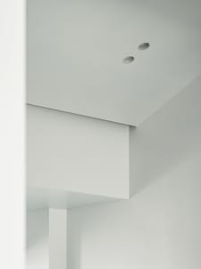 A minimalist interior design with white walls and a clean, uncluttered space.