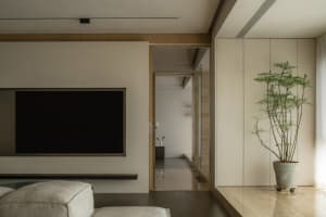 Modern living room featuring sleek, minimalist design with concrete, wood, and metal elements.