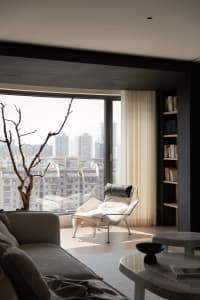 Modern, minimalist living room with a view of the city.