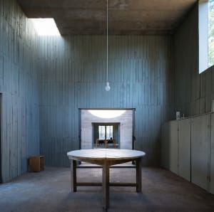 Minimalist room with wooden table and panels on walls