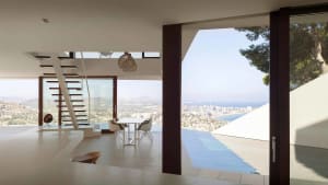Modern residential space featuring glass walls and wooden accents.