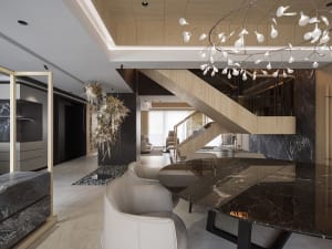 Modern living and dining area with marble, metal, and wooden elements.