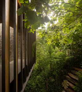 A modern exterior featuring wooden, stone, and metal elements.
