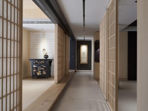 A modern interior design featuring a corridor with wood paneling, minimal lighting, and a calm atmosphere.